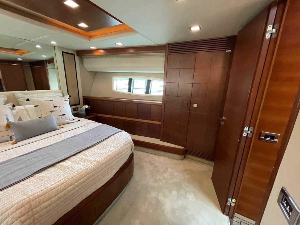 a room with a bed and a closet aboard 2008 AZIMUT 75 FLY @ IXTAPA ZIHUATANEJO Yacht for Sale