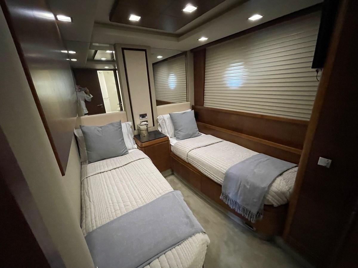 a room with beds and a window aboard 2008 AZIMUT 75 FLY @ IXTAPA ZIHUATANEJO Yacht for Sale