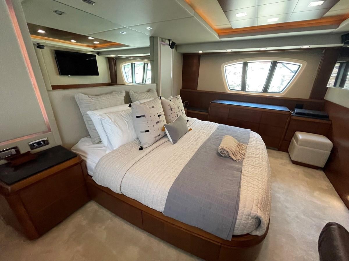 a room with a bed and a window aboard 2008 AZIMUT 75 FLY @ IXTAPA ZIHUATANEJO Yacht for Sale