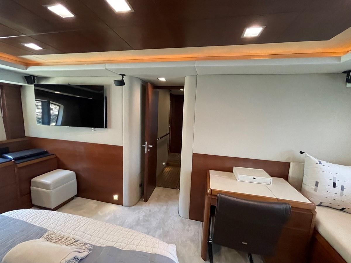 a room with a bed and desk aboard 2008 AZIMUT 75 FLY @ IXTAPA ZIHUATANEJO Yacht for Sale