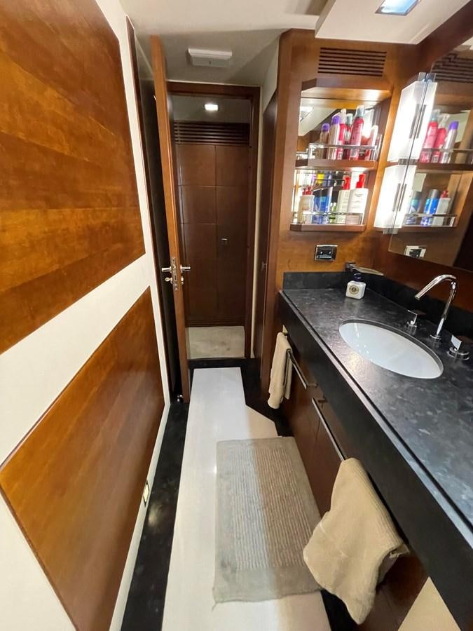 a bathroom with a sink and a mirror aboard 2008 AZIMUT 75 FLY @ IXTAPA ZIHUATANEJO Yacht for Sale