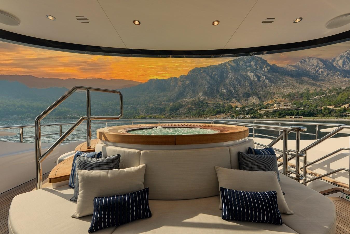 a large bed on a balcony aboard MINE GAMES Yacht for Sale