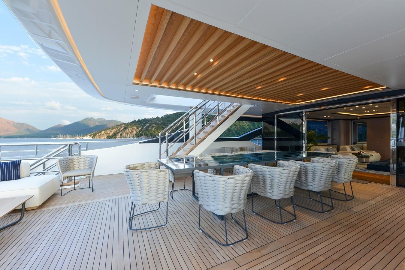 a large patio with tables and chairs aboard MINE GAMES Yacht for Sale