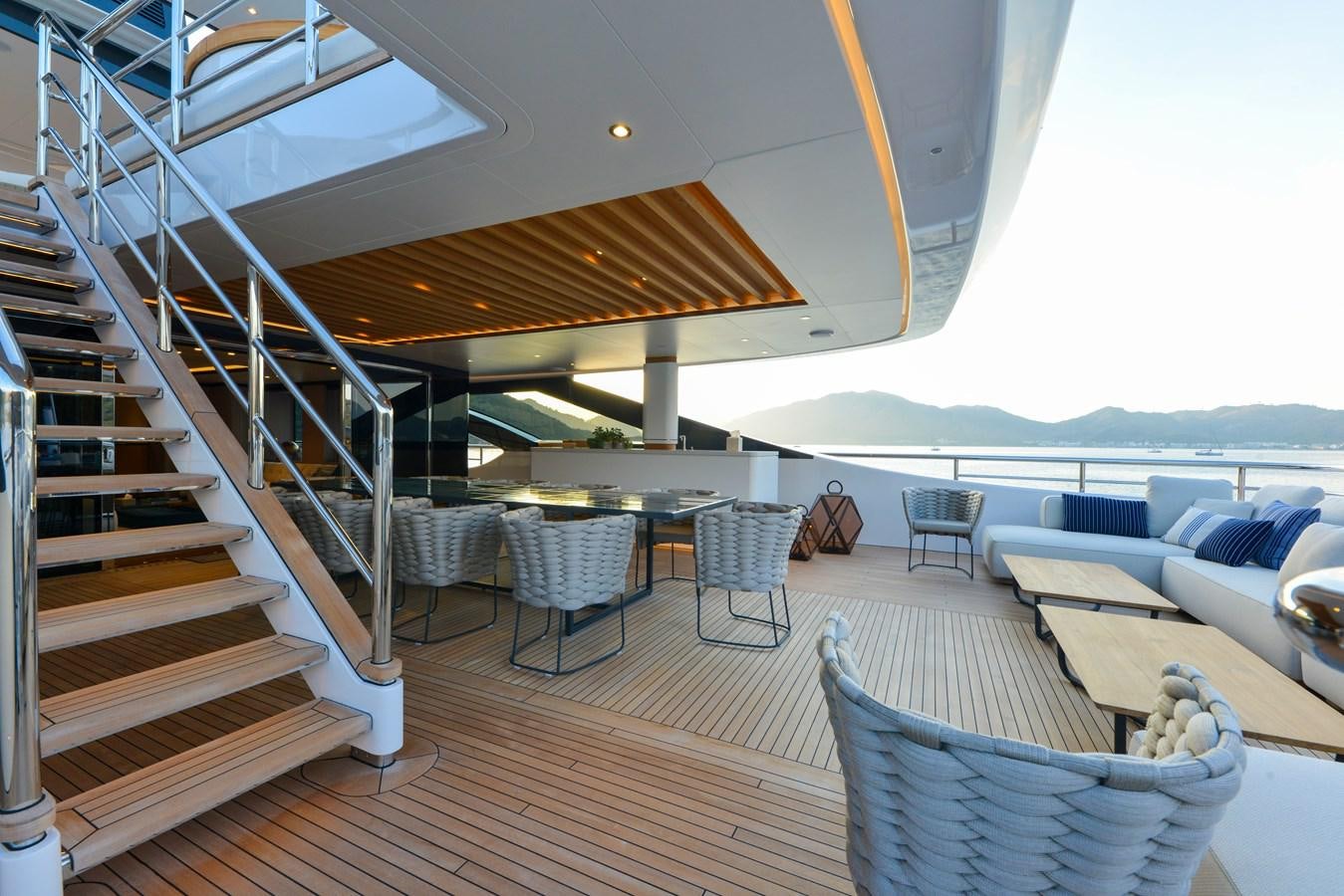 a deck with chairs and tables aboard MINE GAMES Yacht for Sale
