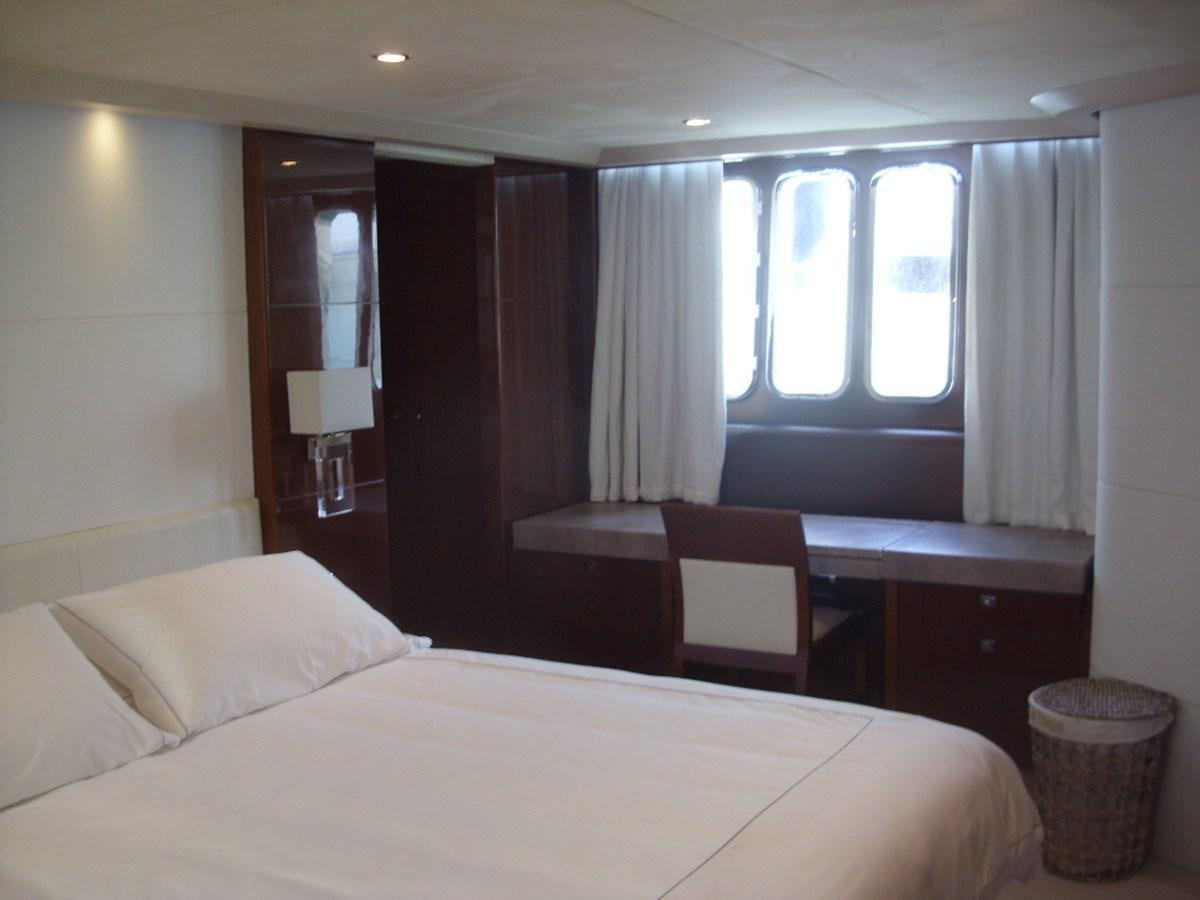 a bed with a desk and a chair in a room aboard WATCHIT Yacht for Sale