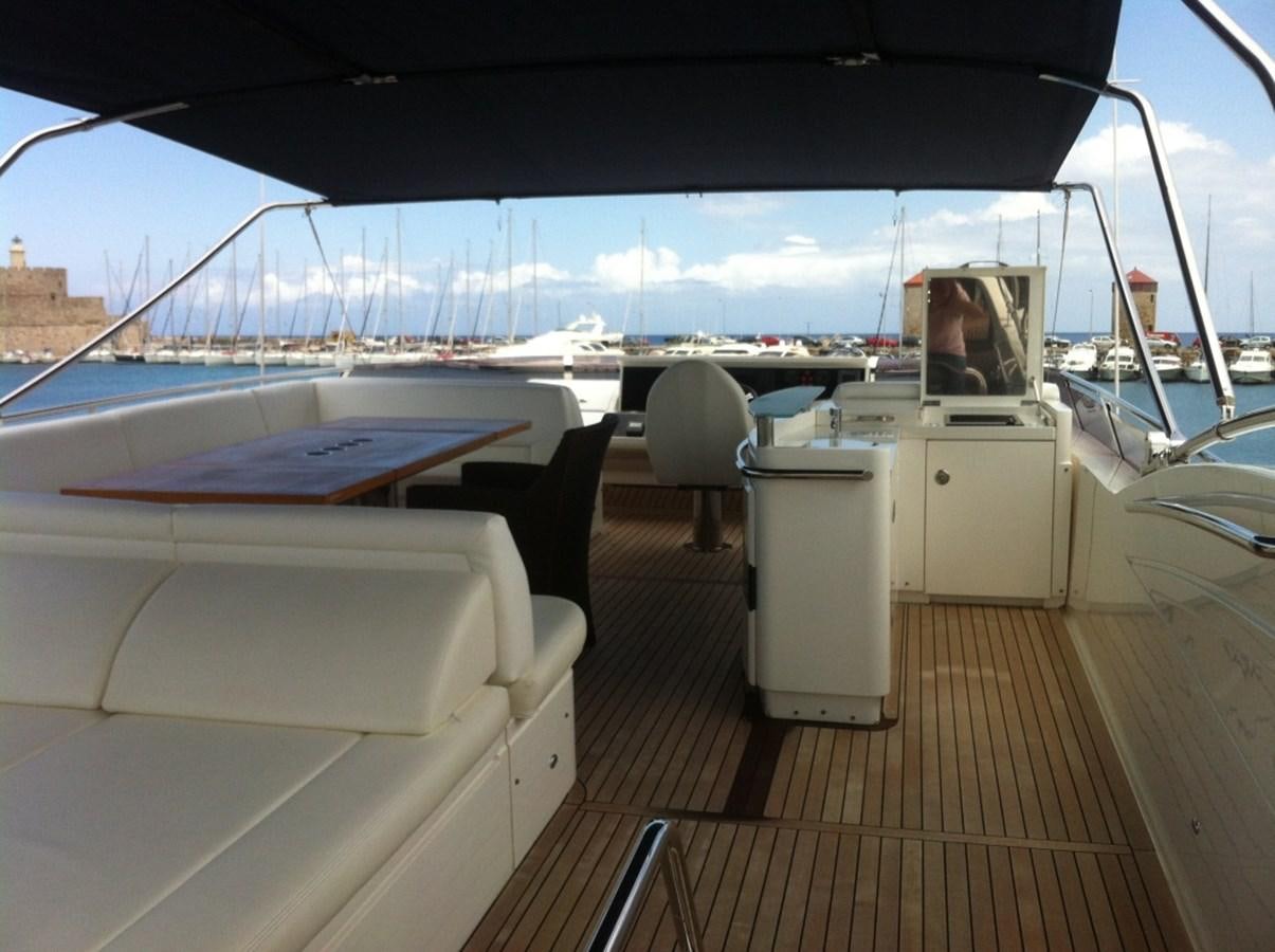 a boat deck with a table and chairs on it aboard WATCHIT Yacht for Sale