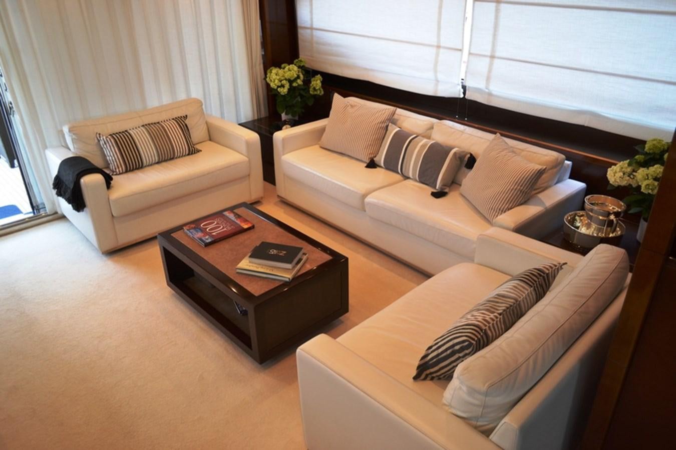 a living room with a couch and coffee table aboard WATCHIT Yacht for Sale