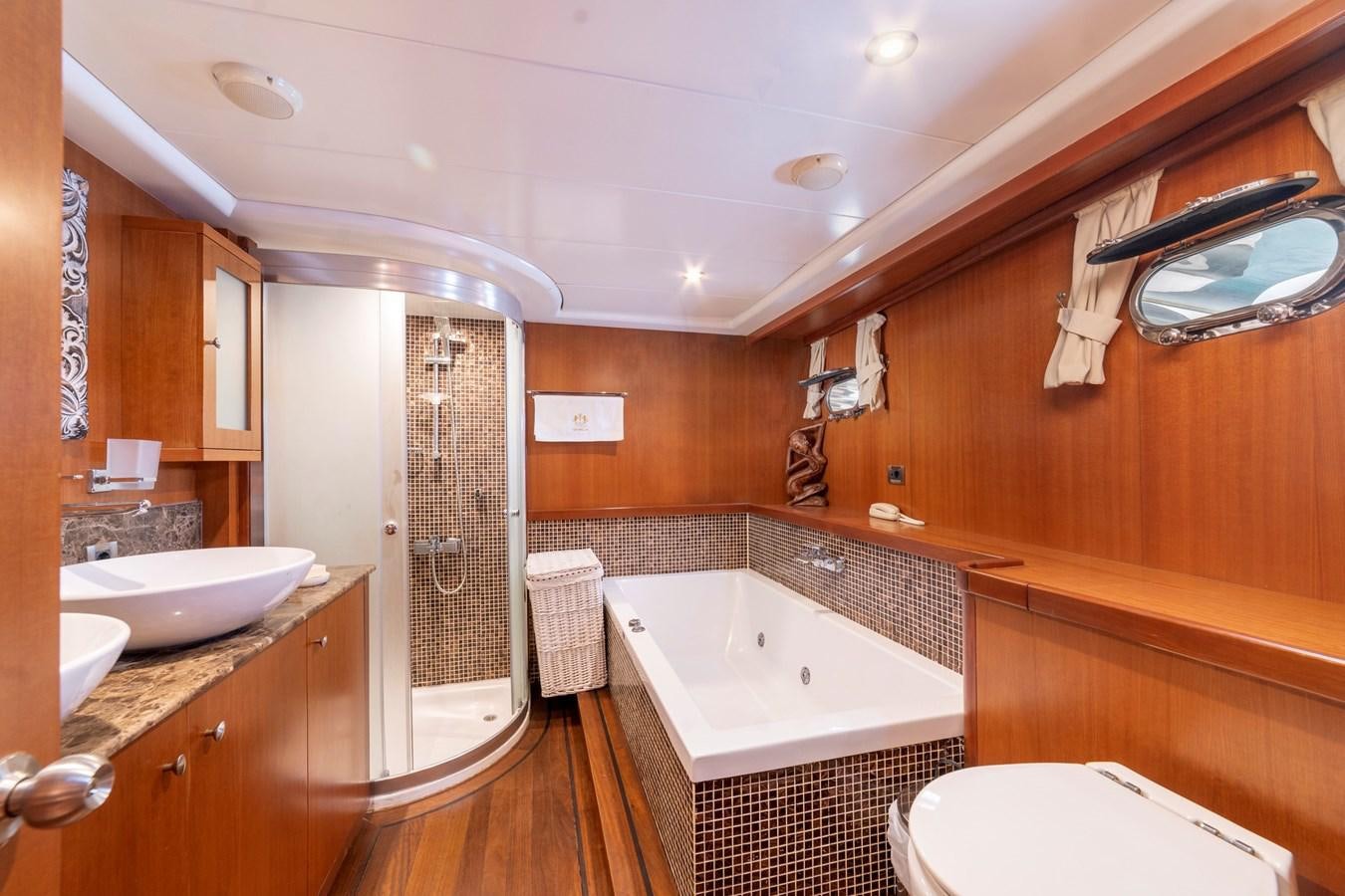 a bathroom with a tub sink and toilet aboard ARABELLA Yacht for Sale