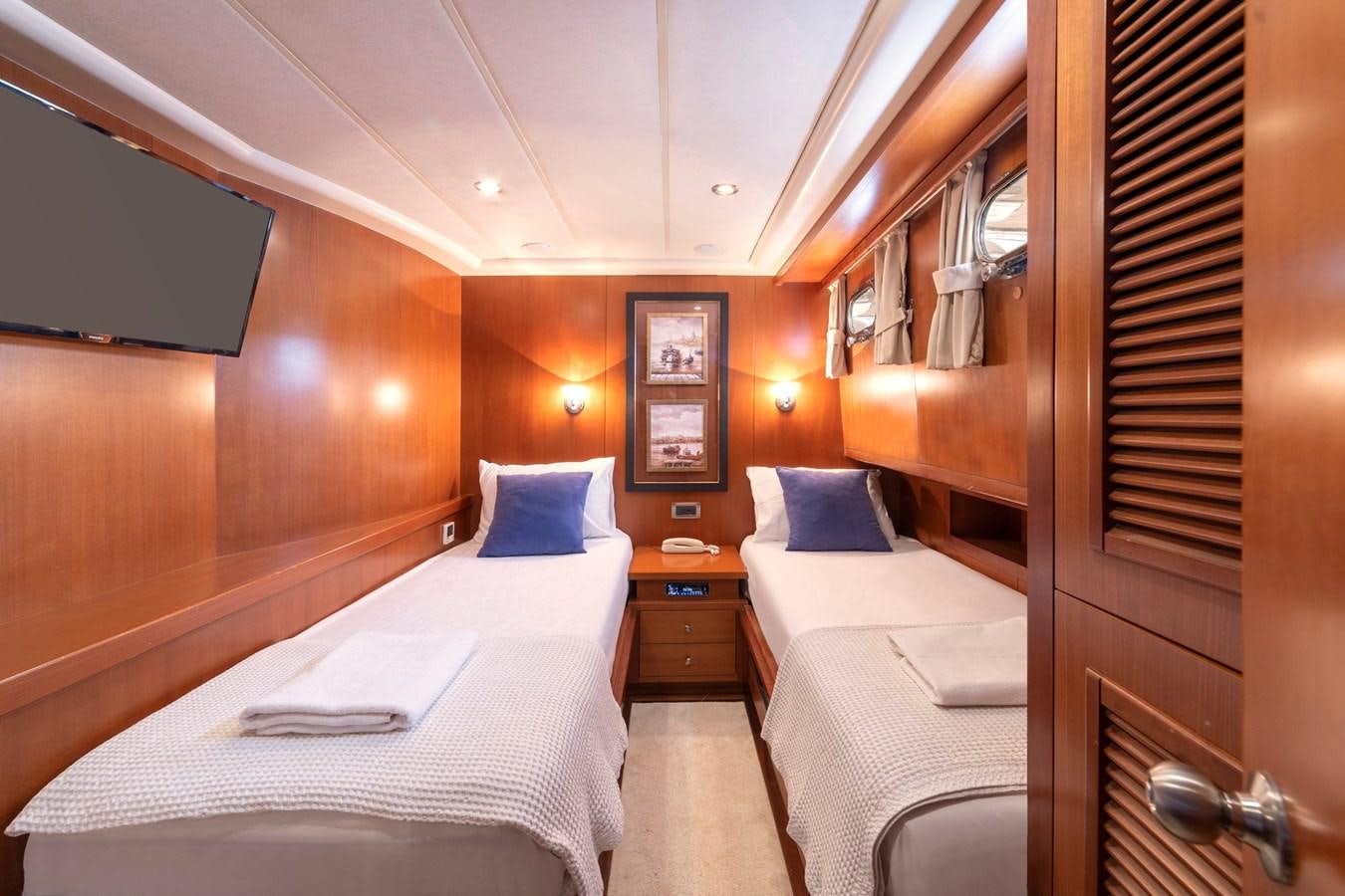 a room with beds and a window aboard ARABELLA Yacht for Sale