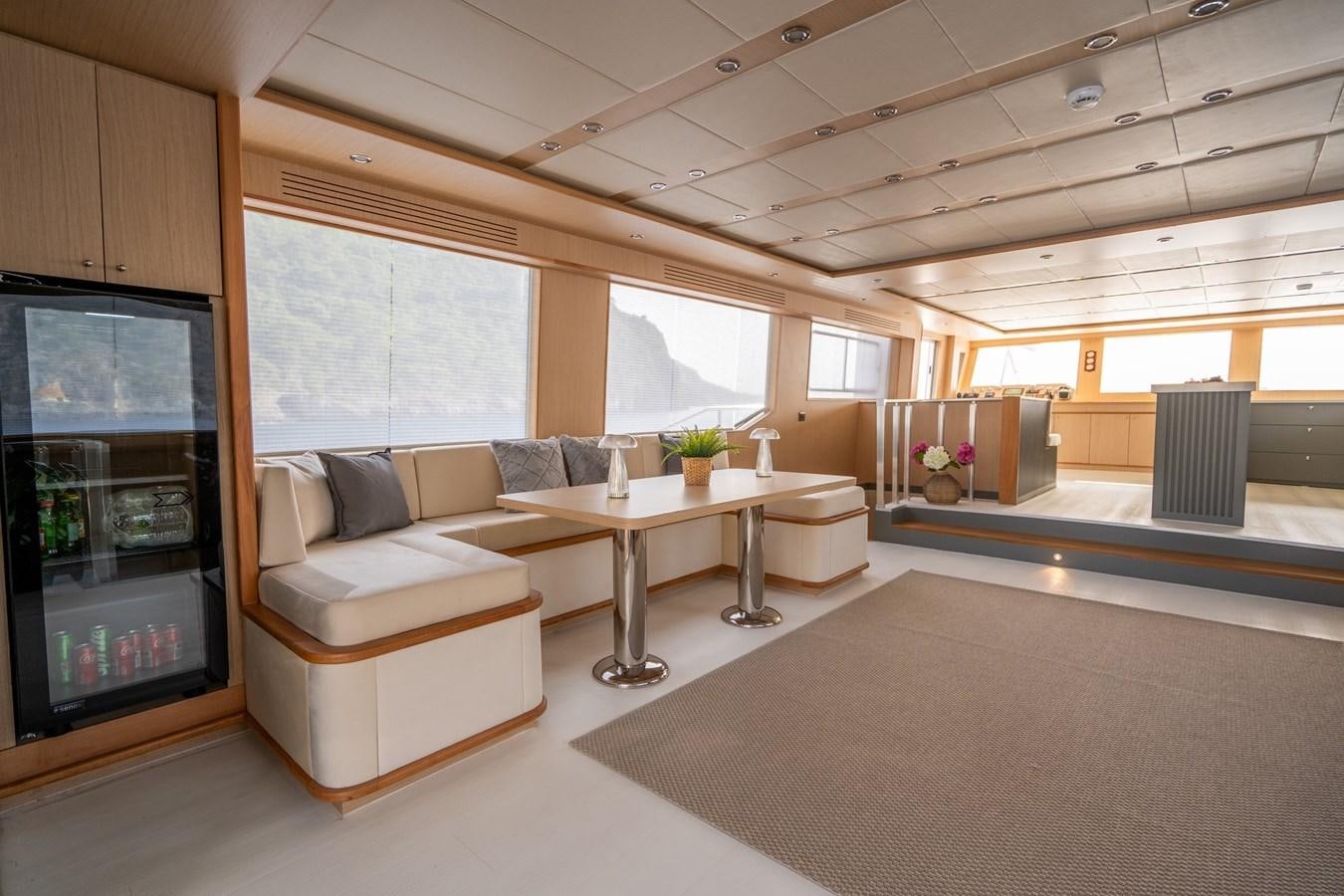 a living room with a couch and a table aboard LAVIN Yacht for Sale
