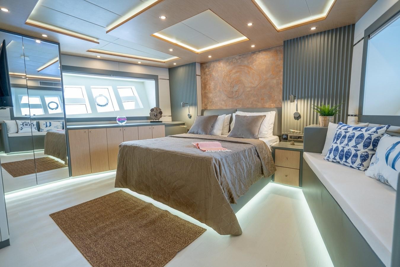 a room with a bed and a window aboard LAVIN Yacht for Sale