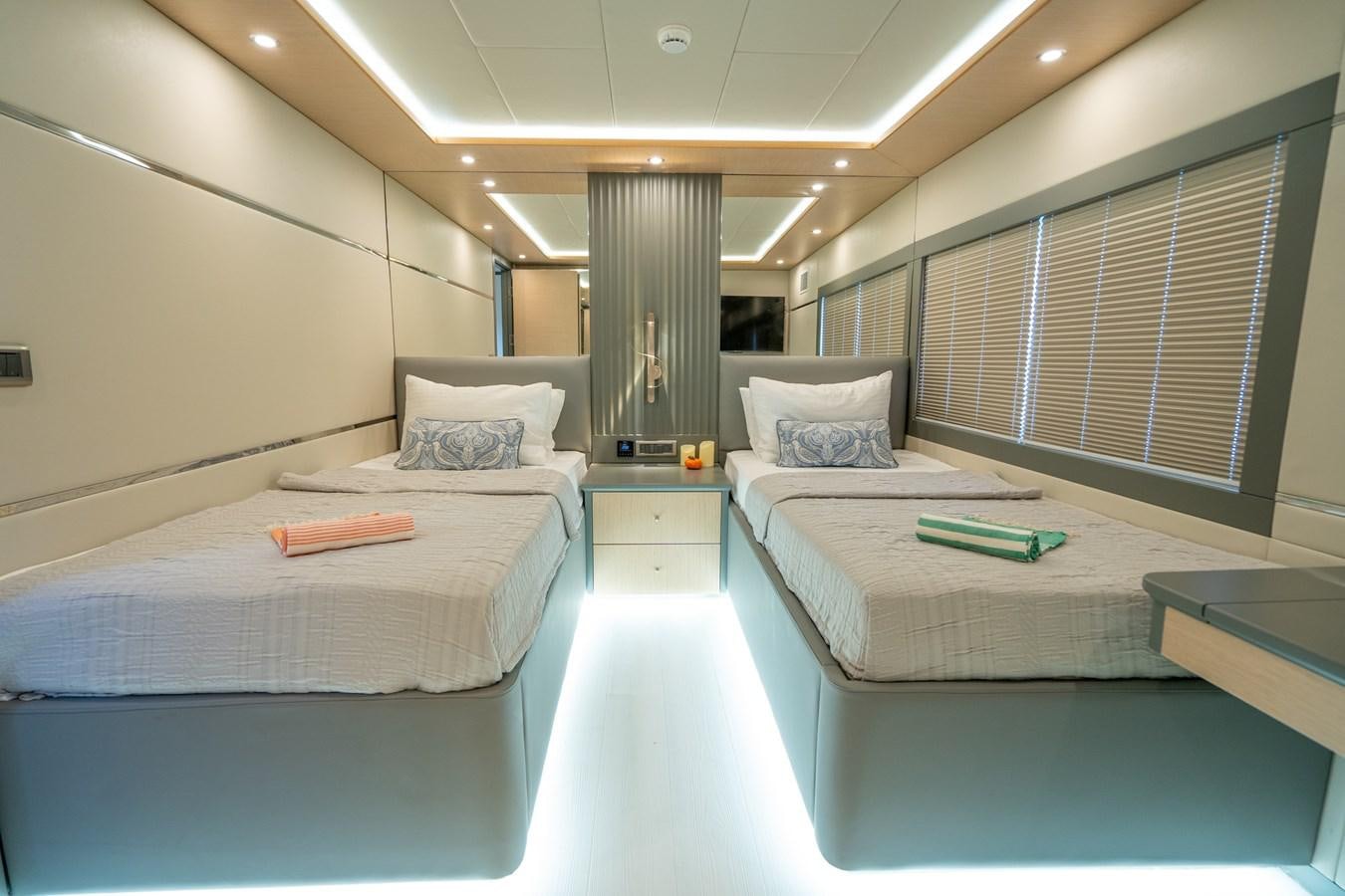 a room with beds and a window aboard LAVIN Yacht for Sale