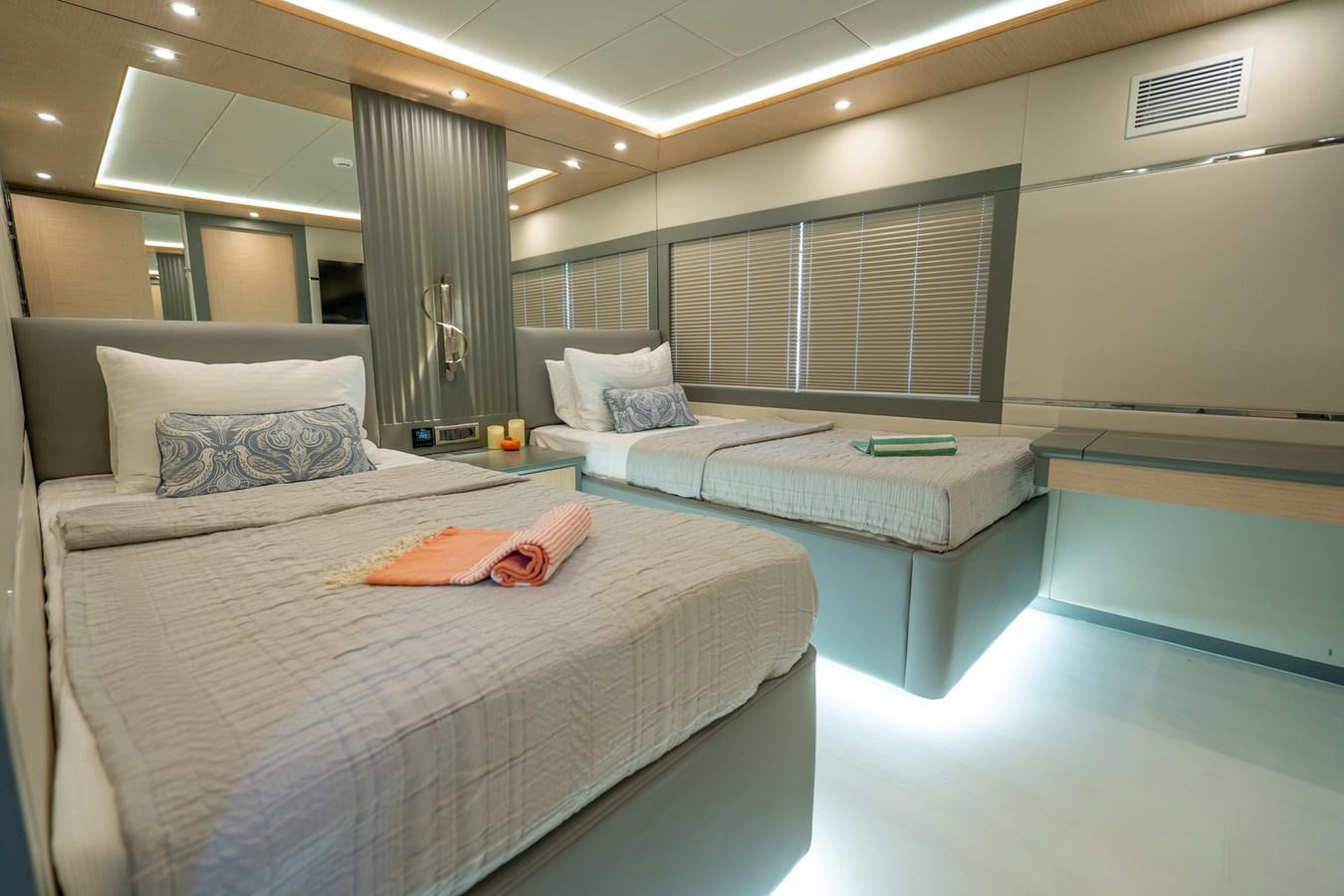 a room with a bed and a table aboard LAVIN Yacht for Sale