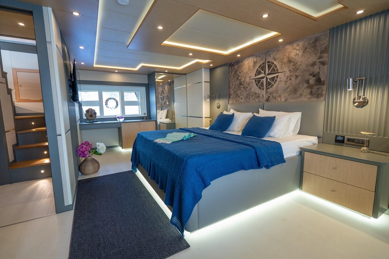 a room with a bed and a desk aboard LAVIN Yacht for Sale