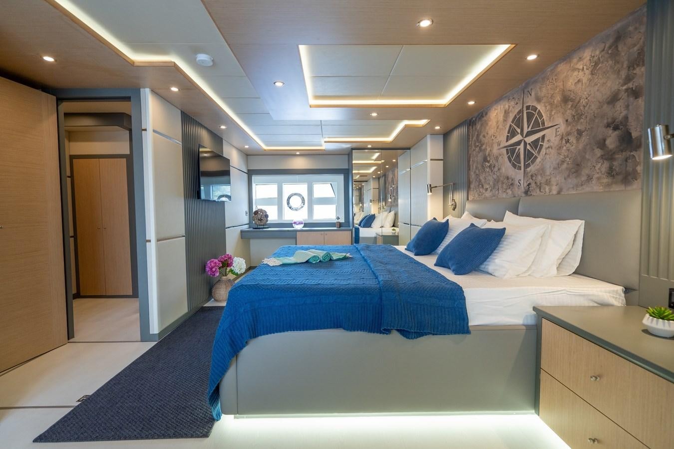 a room with a bed and a desk aboard LAVIN Yacht for Sale
