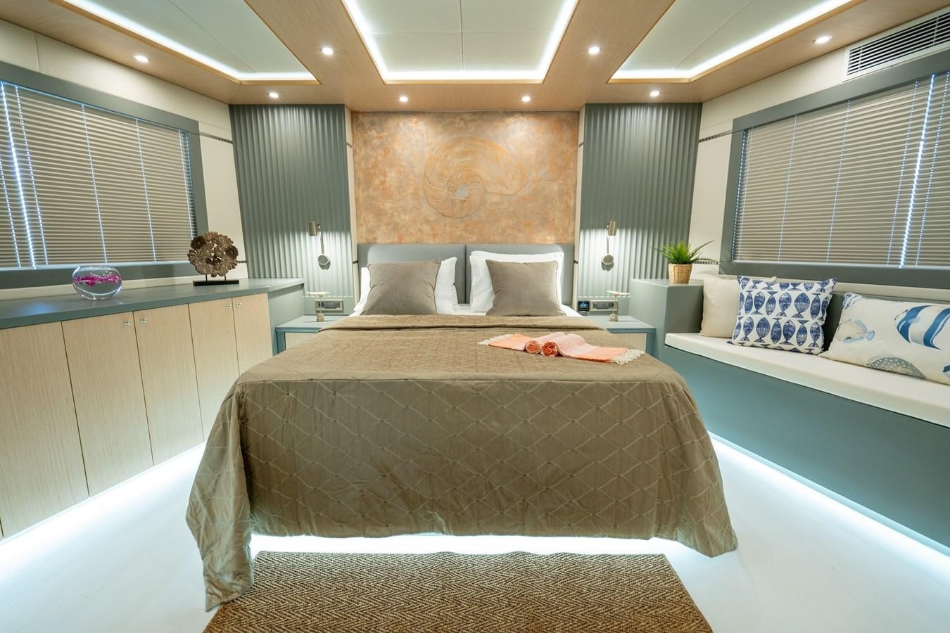 a room with a bed and a window aboard LAVIN Yacht for Sale