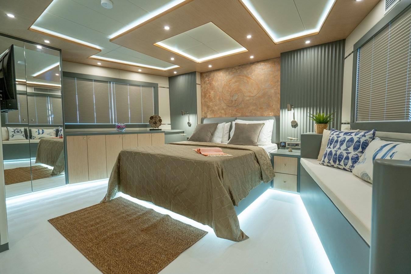 a room with a bed and a desk aboard LAVIN Yacht for Sale
