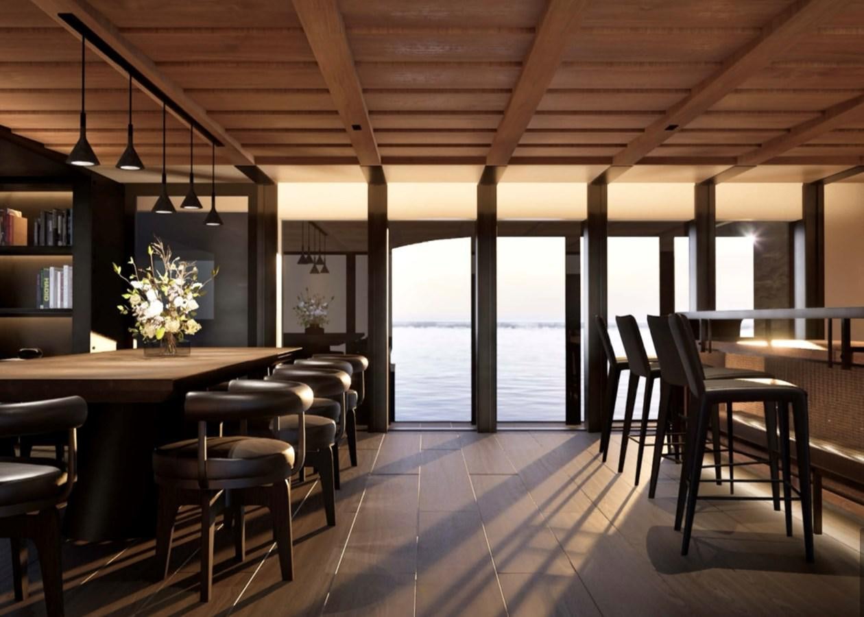 a room with tables and chairs aboard PROJECT ICE Yacht for Sale