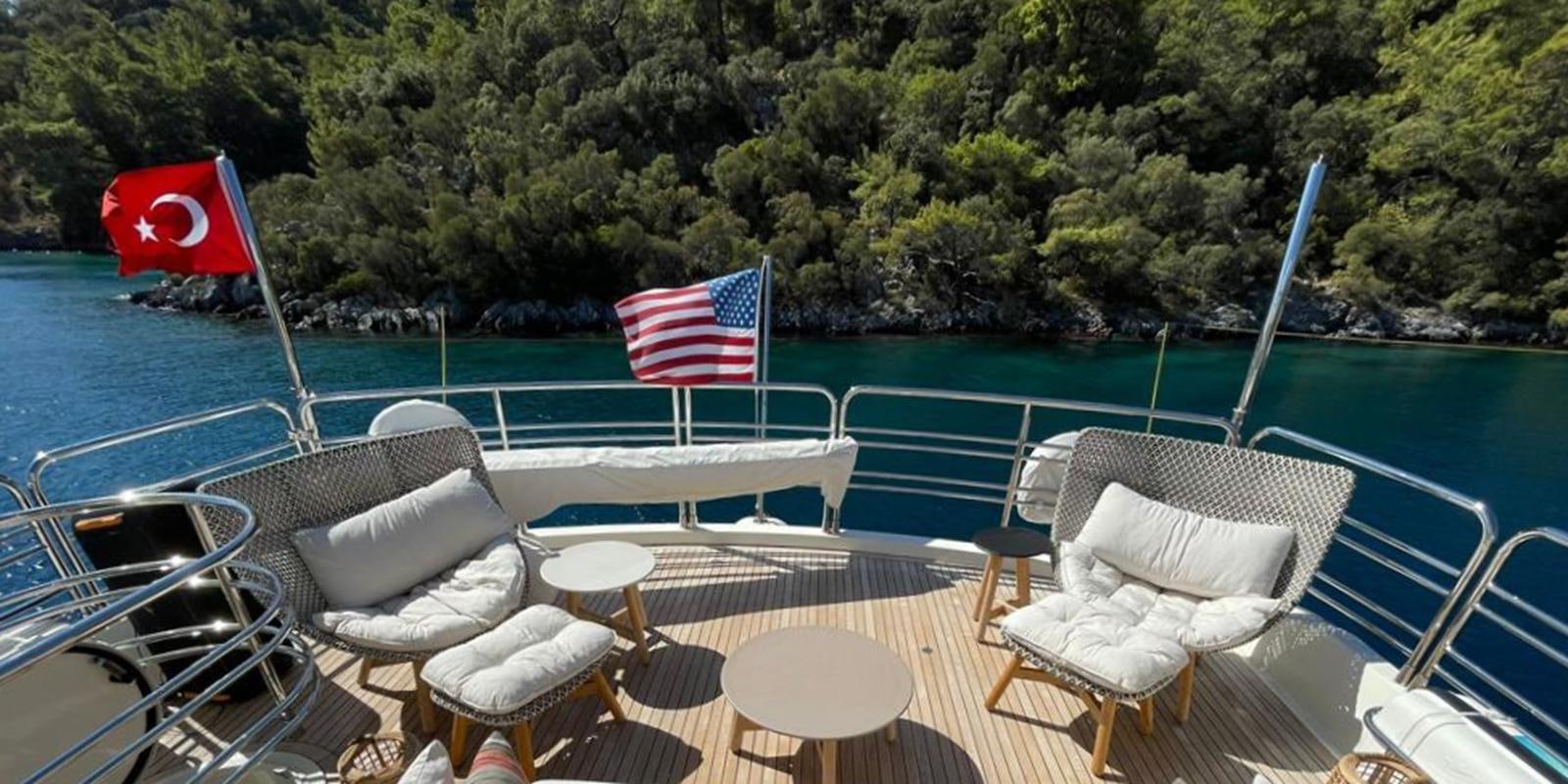 a pool with chairs and tables aboard SWORDFISH 68 Yacht for Sale