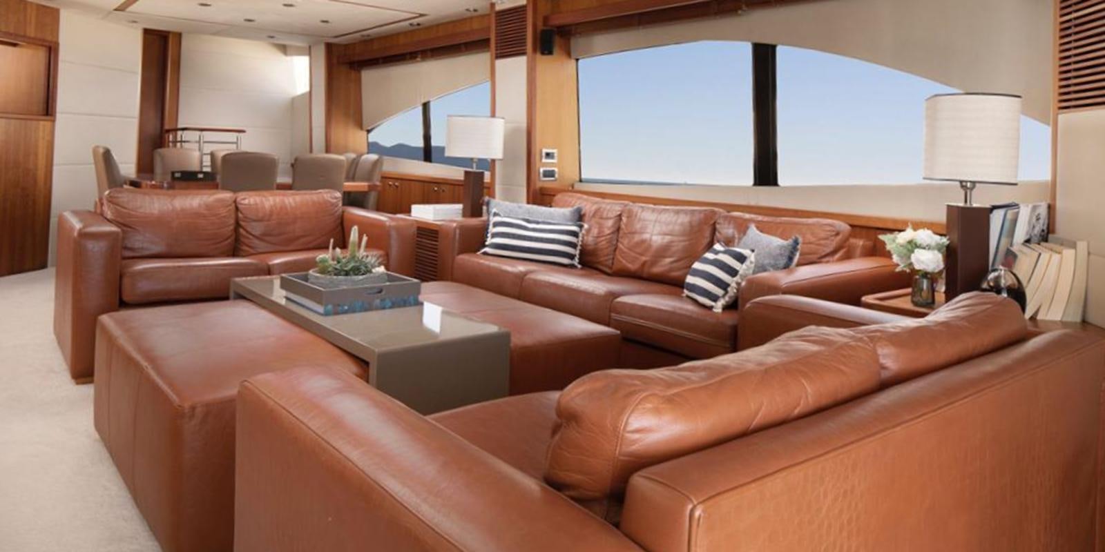 a living room with a large window aboard SWORDFISH 68 Yacht for Sale