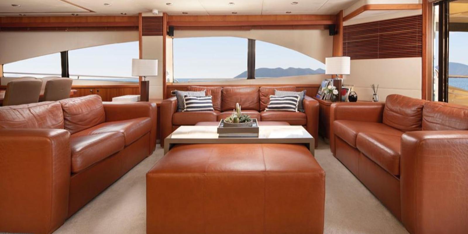 a living room with a large window aboard SWORDFISH 68 Yacht for Sale