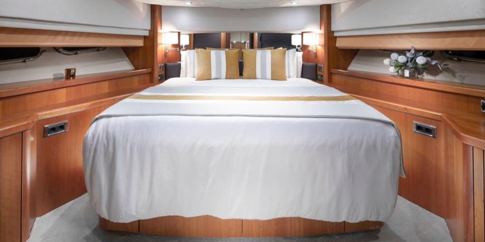 a bed with white sheets aboard SWORDFISH 68 Yacht for Sale