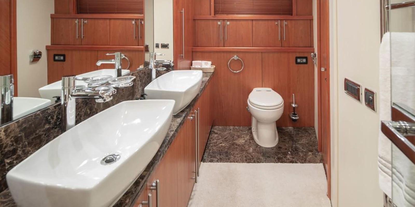 a bathroom with a marble counter top aboard SWORDFISH 68 Yacht for Sale