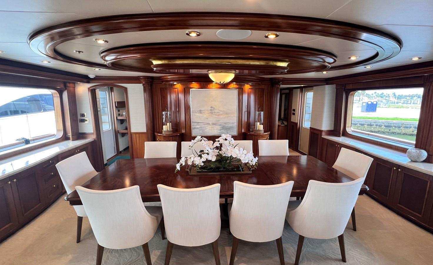 a large dining table with white chairs aboard MISS STEPHANIE Yacht for Sale