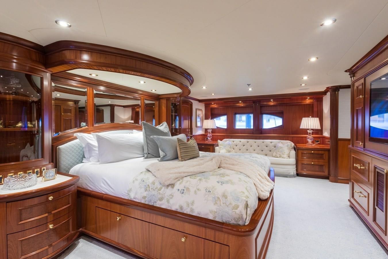 a bedroom with a bed and a mirror aboard MISS STEPHANIE Yacht for Sale