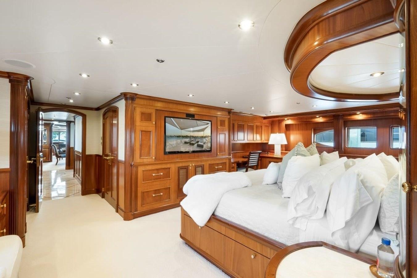 a room with a bed and a wood cabinet aboard MISS STEPHANIE Yacht for Sale