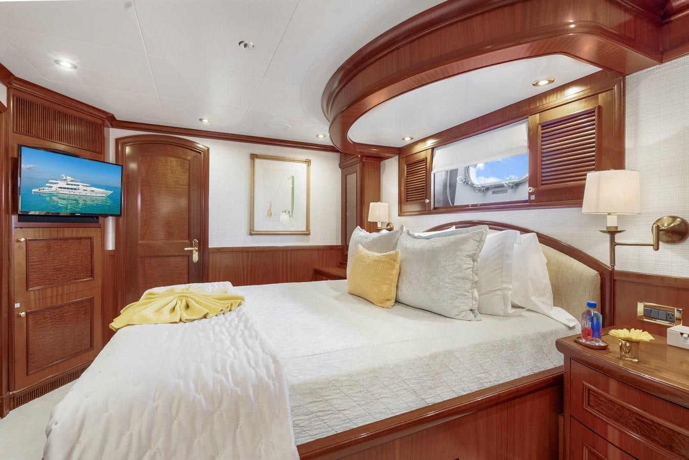 a bed with a television on the wall aboard MISS STEPHANIE Yacht for Sale