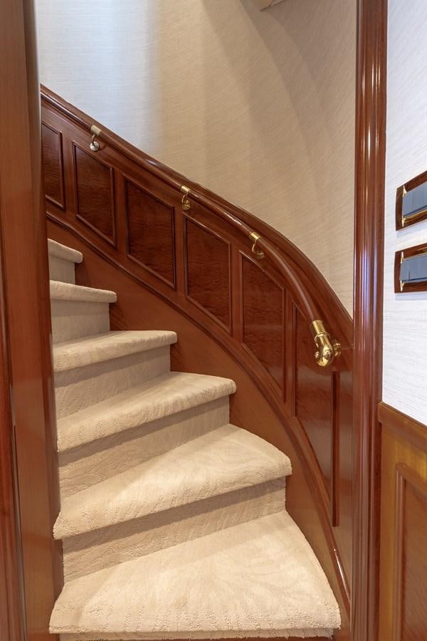 a wooden staircase with a white wall aboard MISS STEPHANIE Yacht for Sale