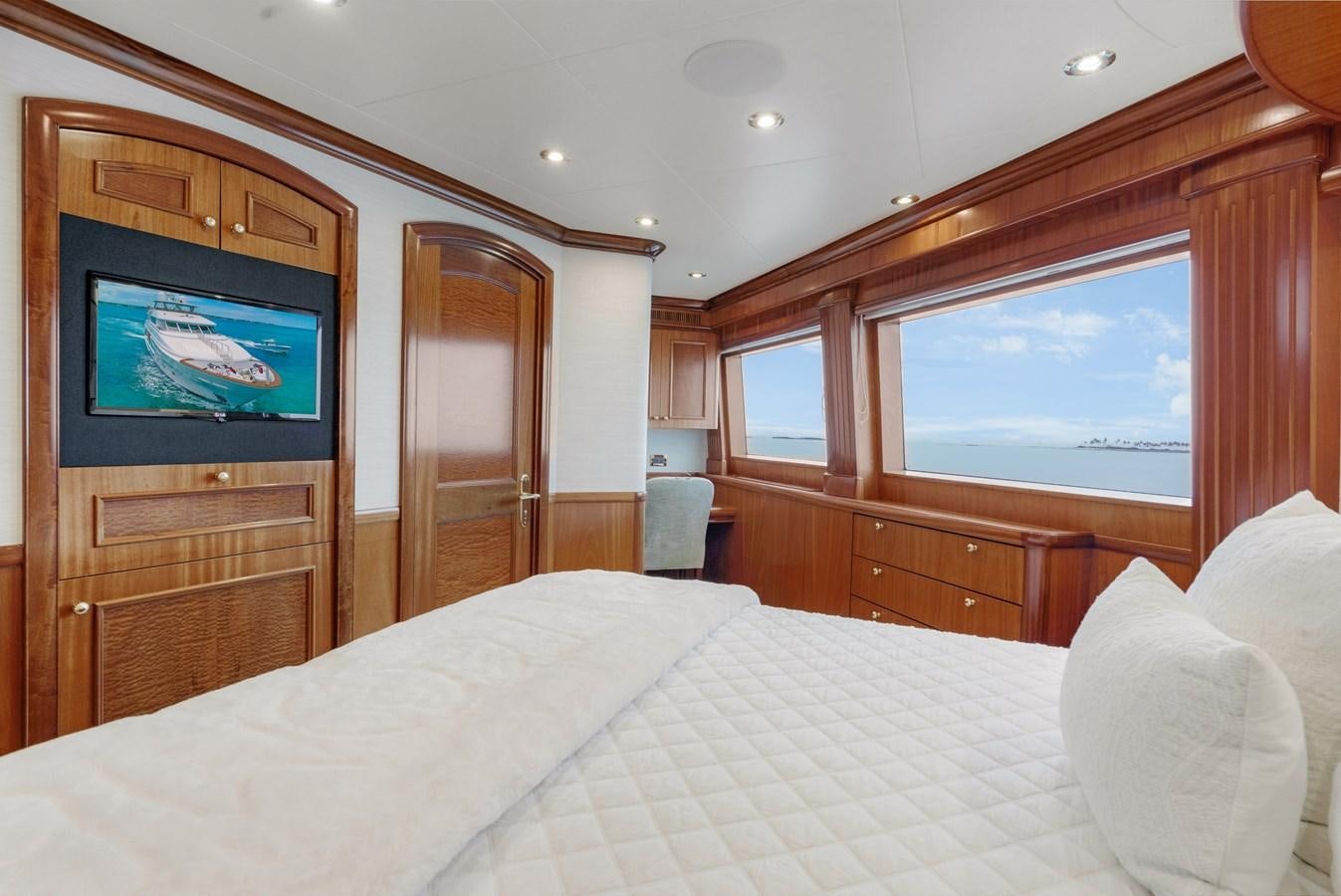 a bed with a television on the wall aboard MISS STEPHANIE Yacht for Sale