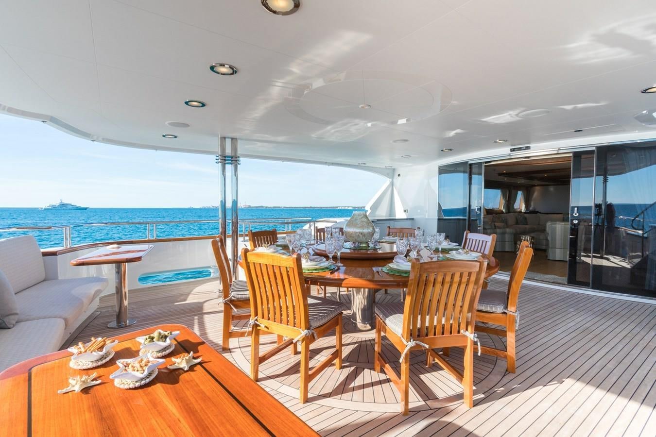 a table and chairs on a deck aboard MISS STEPHANIE Yacht for Sale