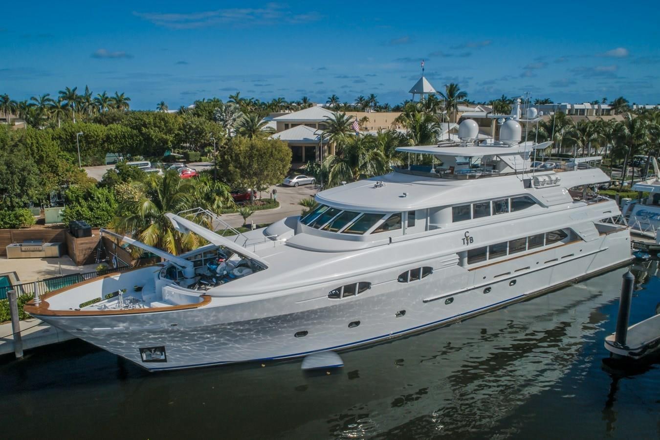 a large white boat in a harbor aboard MISS STEPHANIE Yacht for Sale