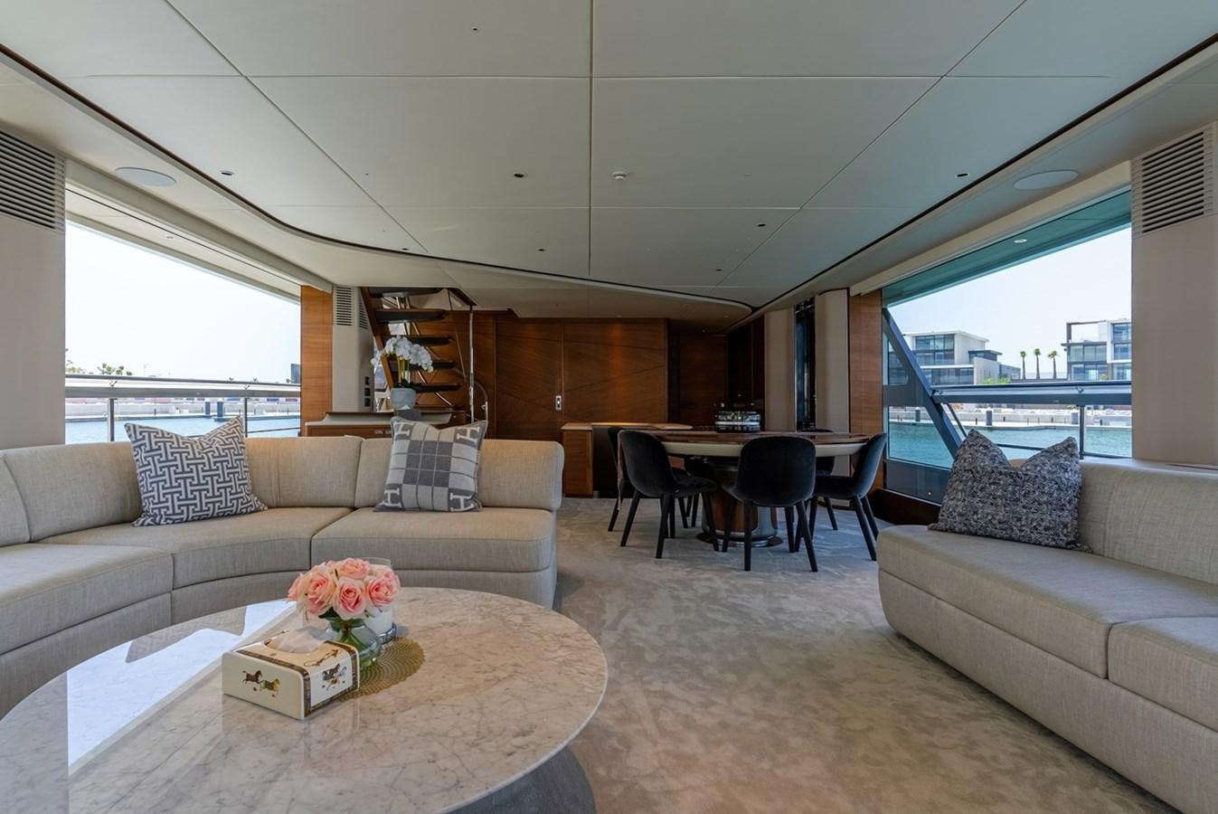 a living room with a couch and a table aboard 2022 PRINCESS X95 Yacht for Sale