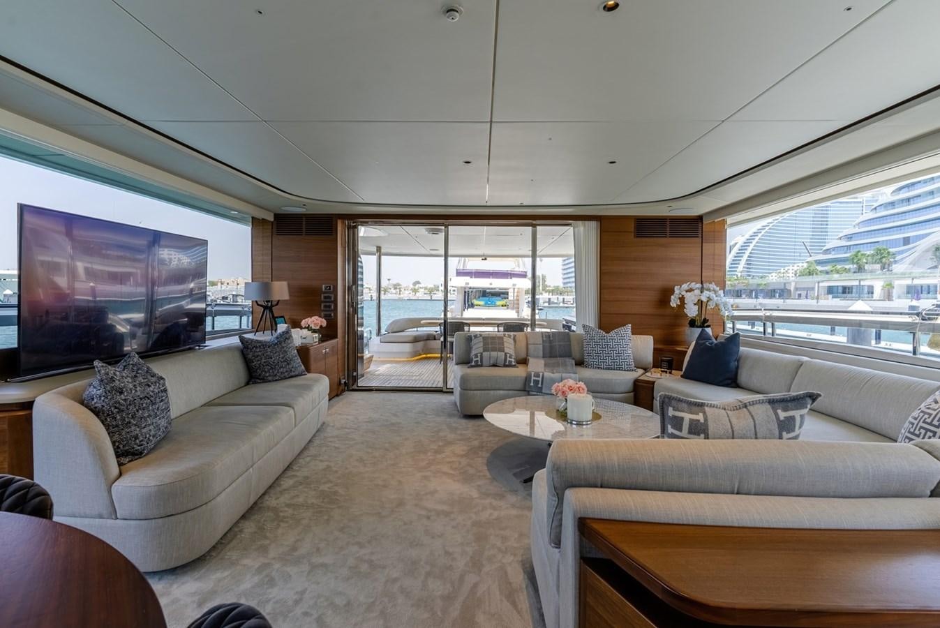 a living room with a large window aboard 2022 PRINCESS X95 Yacht for Sale