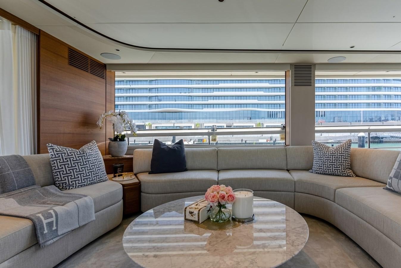 a living room with a couch and a table aboard 2022 PRINCESS X95 Yacht for Sale