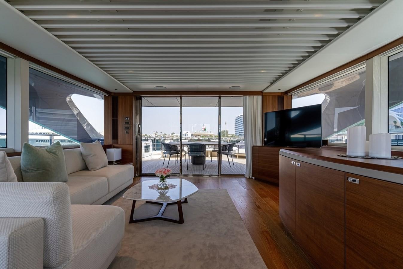a living room with a large window aboard 2022 PRINCESS X95 Yacht for Sale