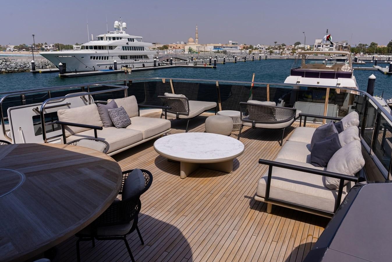 a deck with a view of a large ship and a large cruise ship in the background aboard 2022 PRINCESS X95 Yacht for Sale