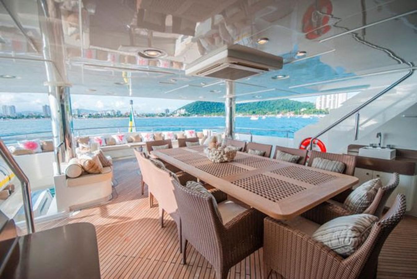 a boat with a table and chairs aboard 2024 MCP MY 140 Yacht for Sale