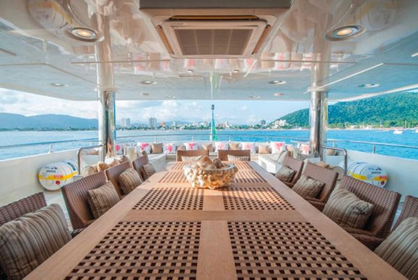 a large room with a table and chairs on it aboard 2024 MCP MY 140 Yacht for Sale