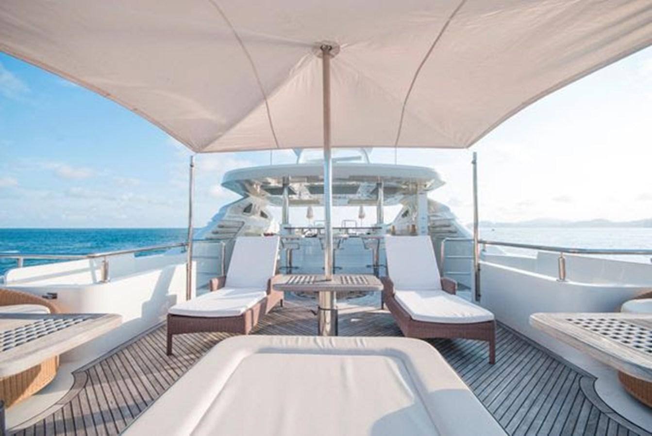 a deck with a table and chairs on it aboard 2024 MCP MY 140 Yacht for Sale