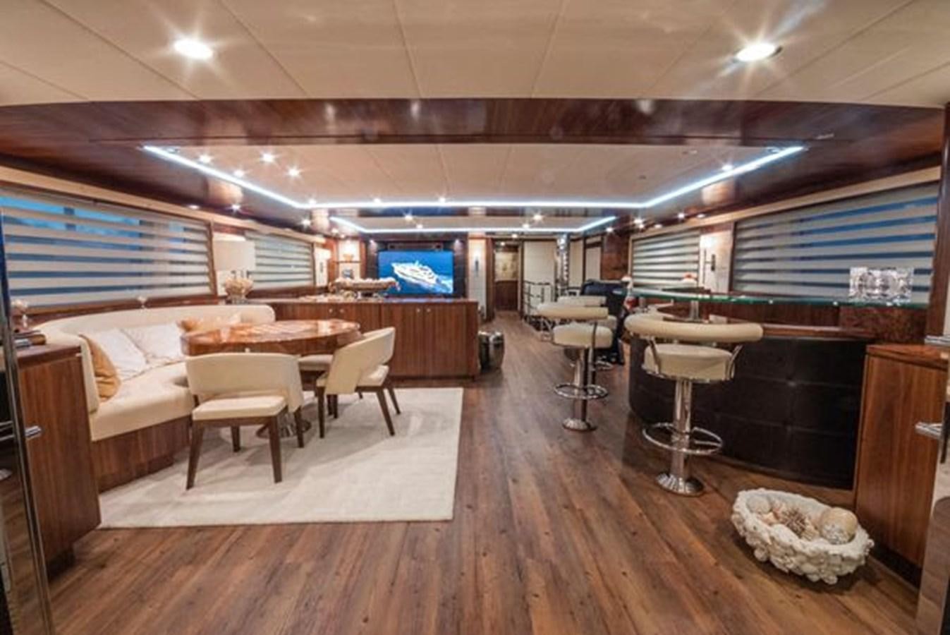 a room with tables and chairs aboard 2024 MCP MY 140 Yacht for Sale