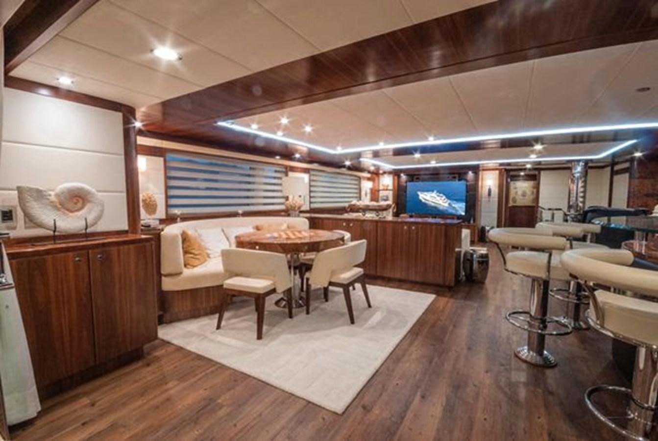 a room with a table chairs and a tv aboard 2024 MCP MY 140 Yacht for Sale