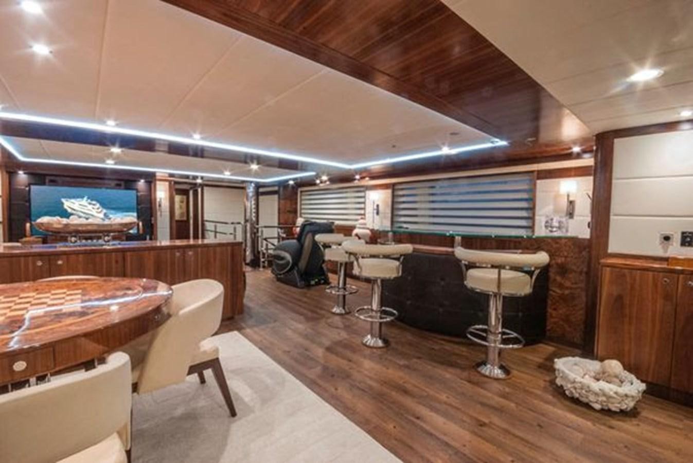 a room with tables and chairs aboard 2024 MCP MY 140 Yacht for Sale