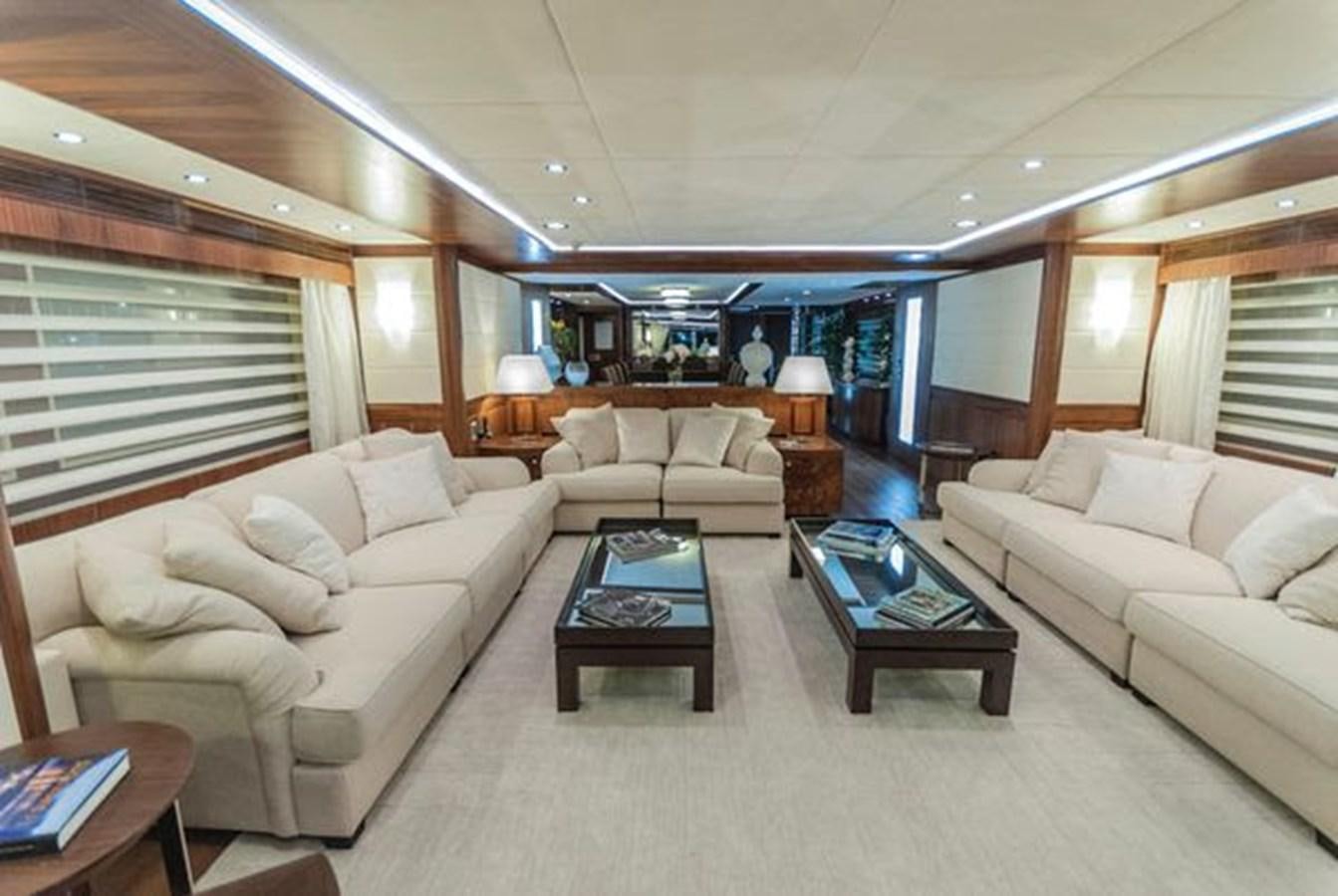 a living room with a couch and a coffee table aboard 2024 MCP MY 140 Yacht for Sale