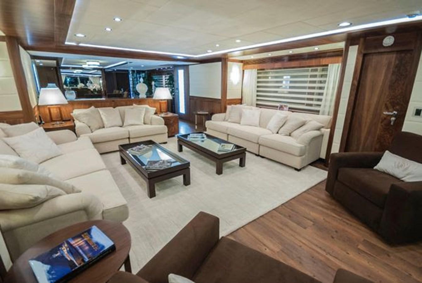 a living room with a couch and a coffee table aboard 2024 MCP MY 140 Yacht for Sale