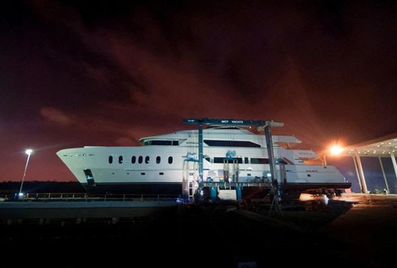 a boat on a dock at night aboard 2024 MCP MY 140 Yacht for Sale