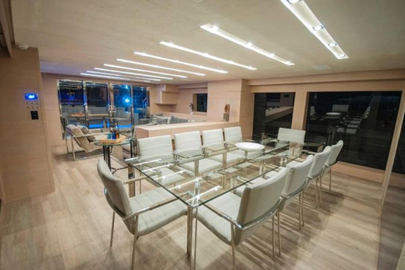 a room with tables and chairs aboard 2024 MCP 106 LE Yacht for Sale